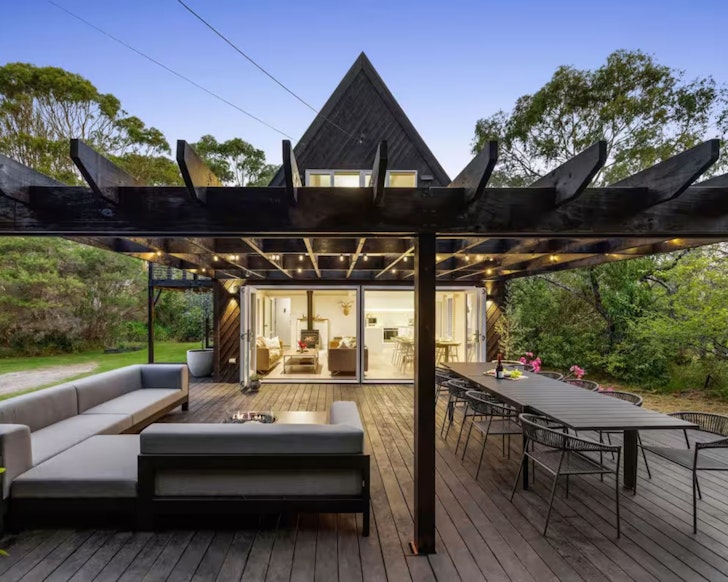 The entertaining space with the pitched black roof of The Coast & Country Cottage luxury Airbnb accommodation Mornington Peninsula