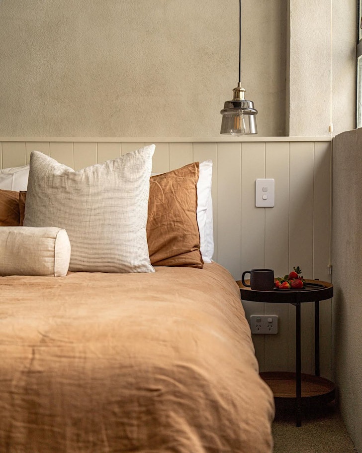 an industrial-vibe bed in a ginger plush duvet