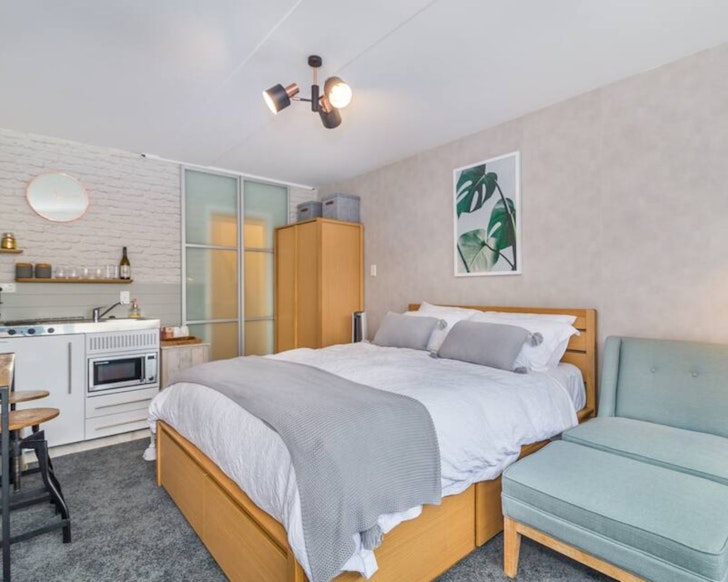 The cosy bedroom and kitchenette at The Cube one of the best Wellington Airbnbs