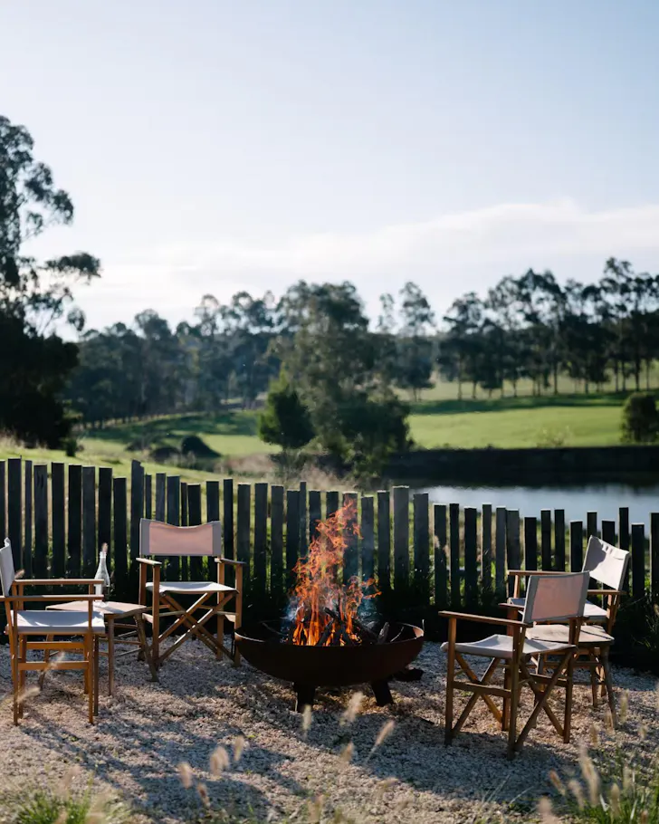 A crackling fire outside on the pebbled grounds of The Farmhouse
