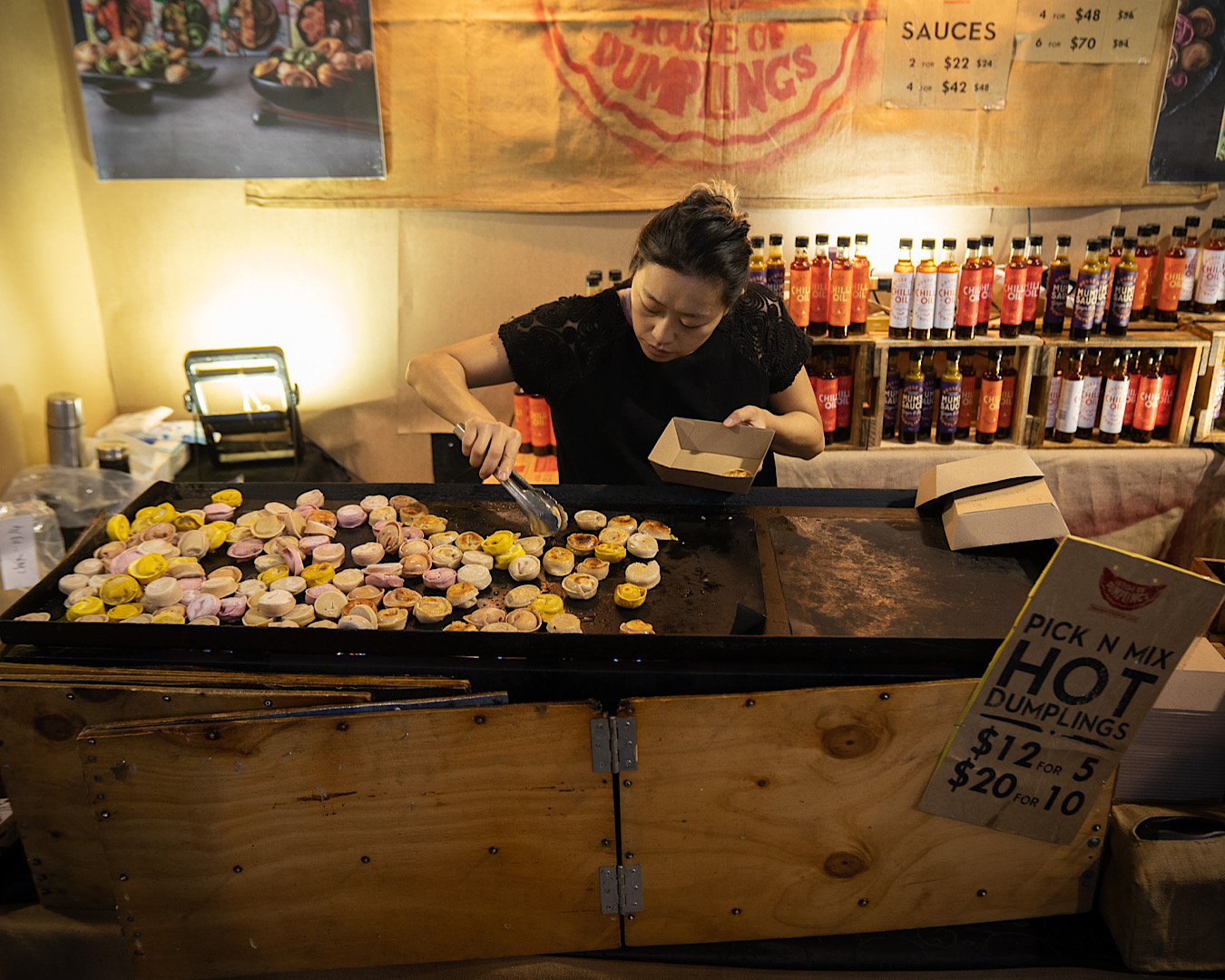A chef carefully cooks dumplings on a grill at The Food Show, one of the best things to do in Christchurch in 2024. 
