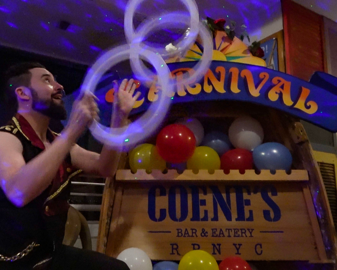 A person juggling hoops in a carnival