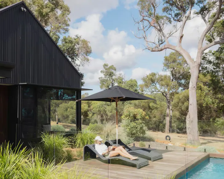 A woman by the pool at The Grove Luxury Escape one of the best WA romantic getaways