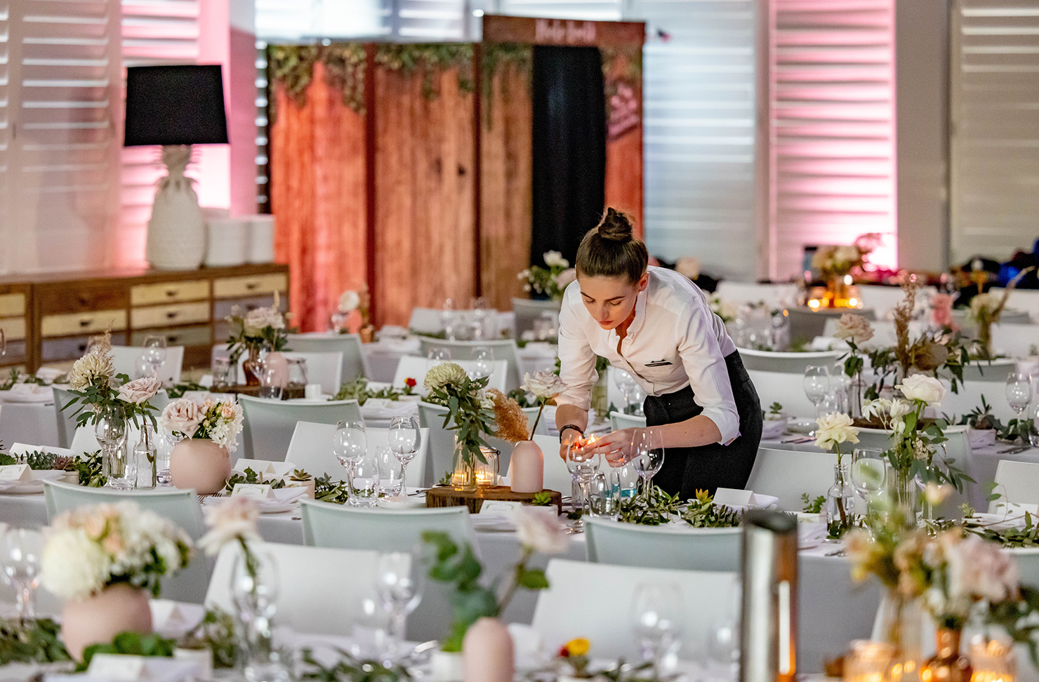 a caterer setting up the interior of a wedding venue