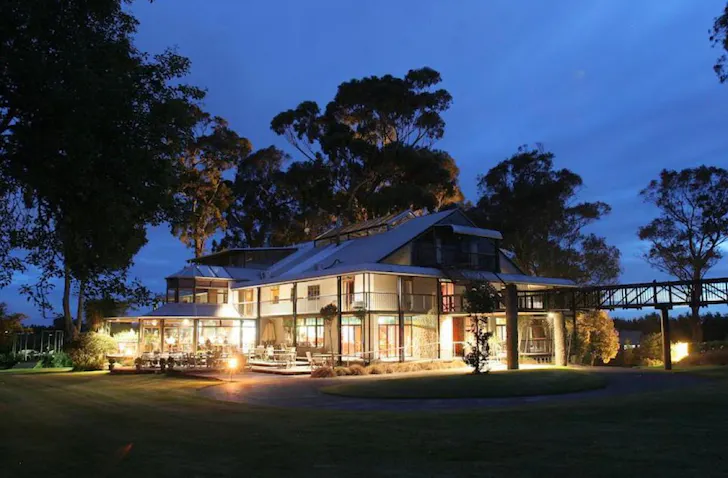 A large Hamilton B&B is aglow with light against the evening sky. 