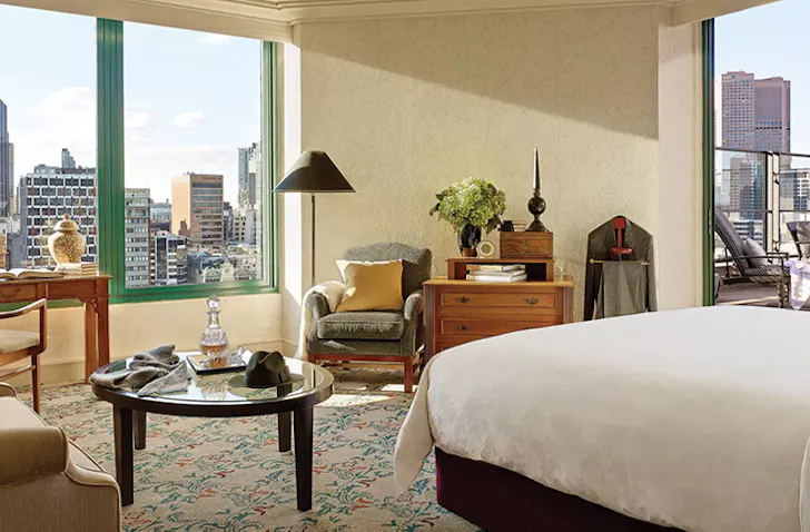 A bedroom with a view at The Langham one of the best Melbourne luxury hotels