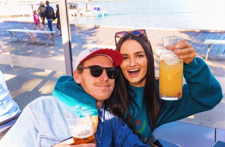 Two people drinking on the waterfront