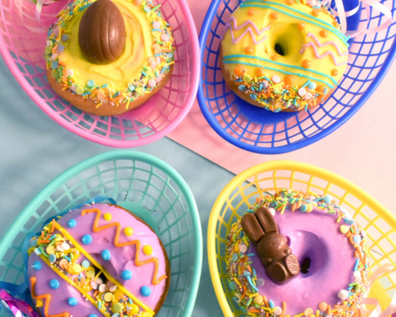 A selection of vibrant Easter donuts complete with Easter eggs, sprinkles, and chocolate bunnies. 