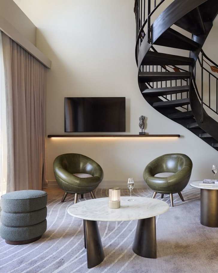 A view of a spiral staircase and lounge in a room at The Playford, one of the best Adelaide hotels
