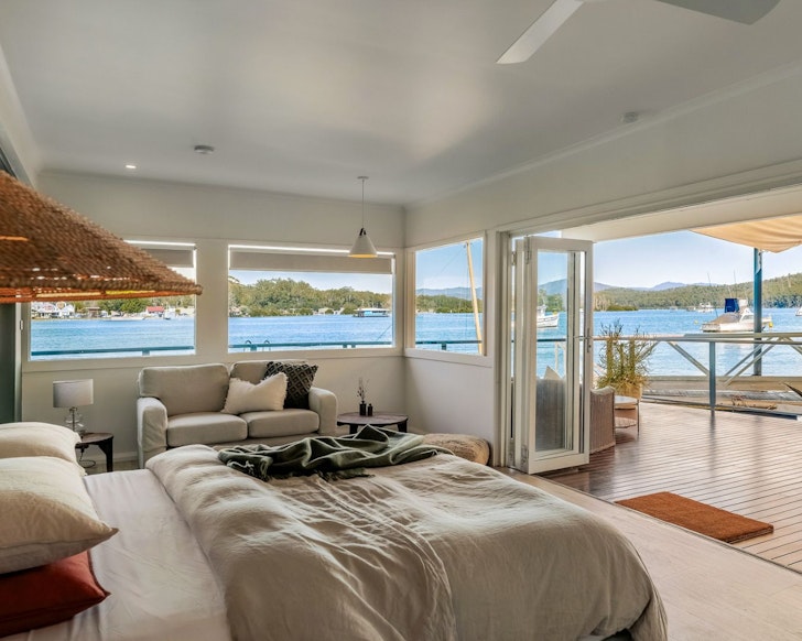 The bedroom with a river view at The Punt House best NSW AIrbnbs