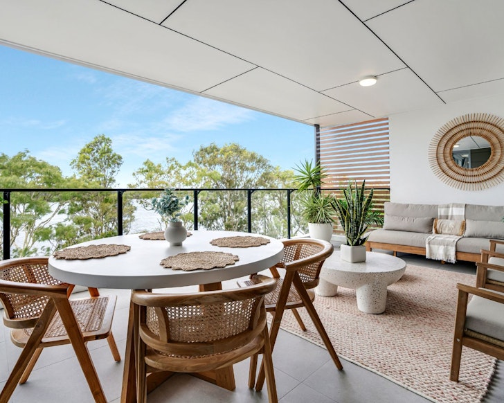The balcony with a water view atq The River Residence best beach house Airbnbs near brisbane