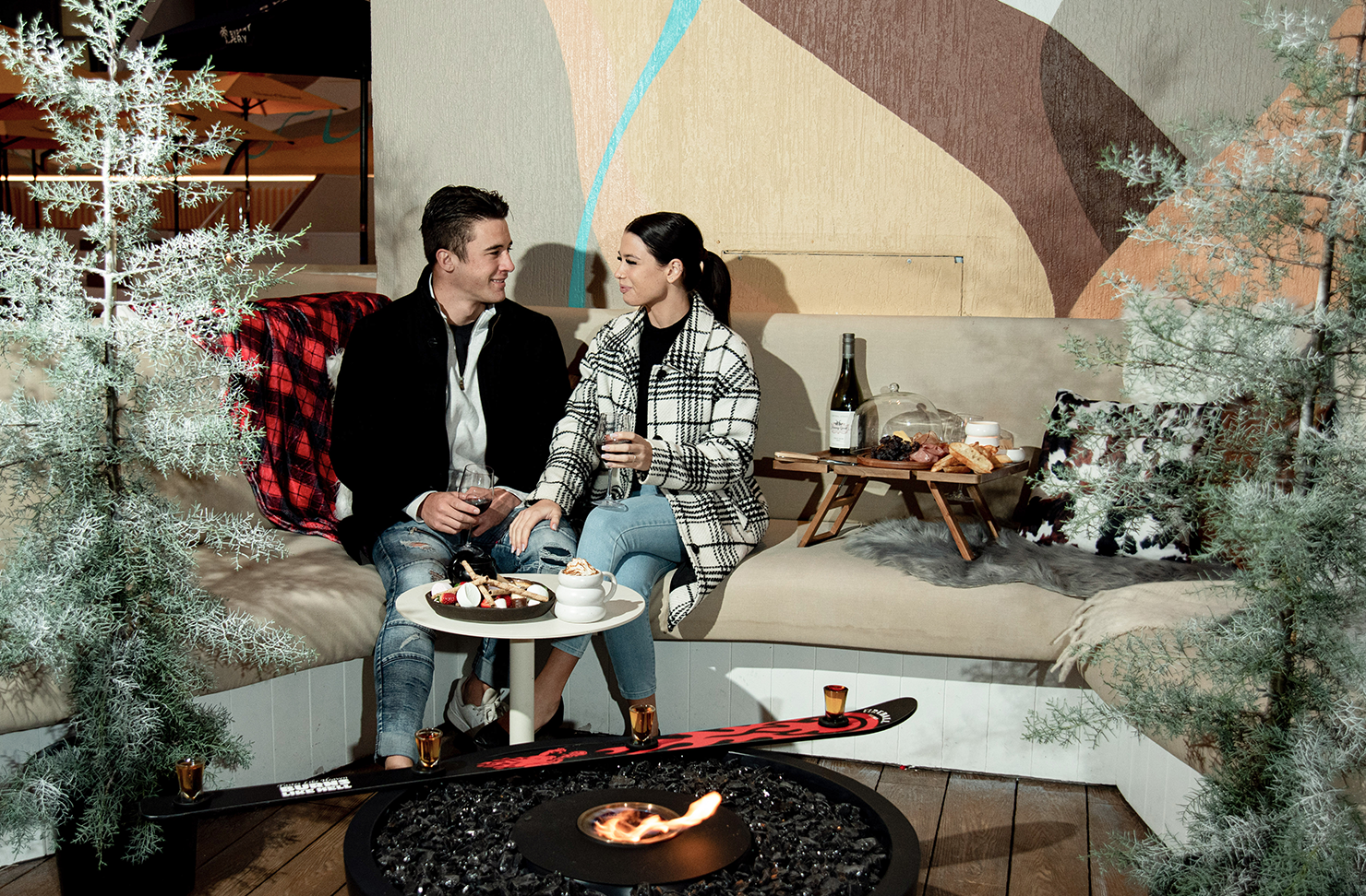 a couple sitting in a luxe winter lodge