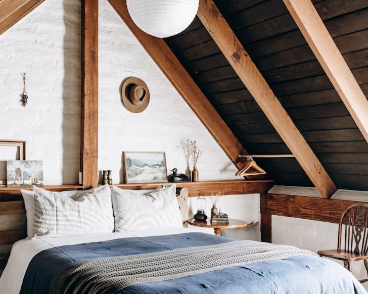 A view of the bedroom and the pitched roof at The Stable Lofts Airbnb one of the best stays in Tasmania
