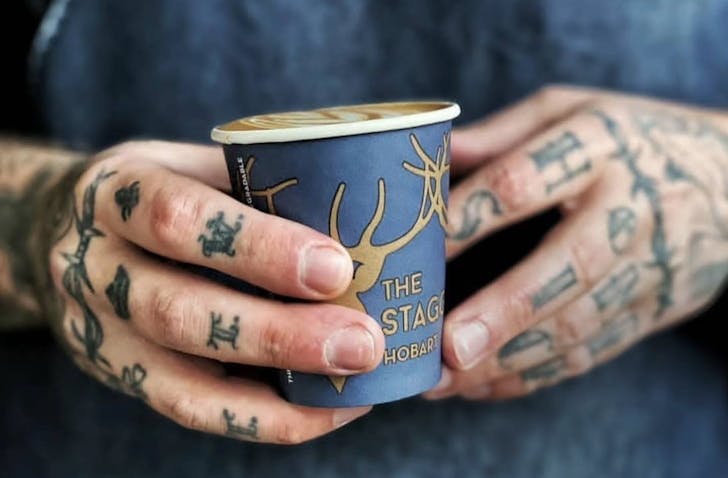 Man holding coffee cup.