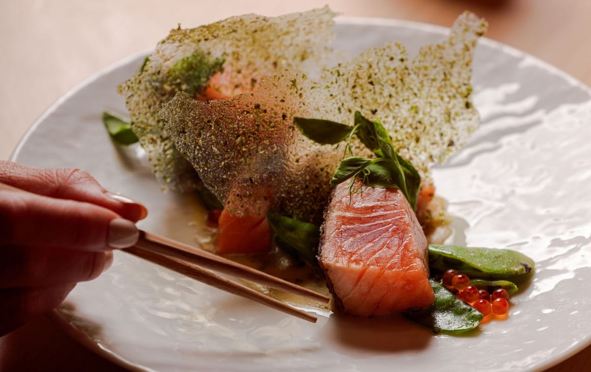 Eating a fish meal using chopstick