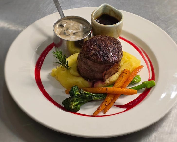 A perfectly cooked steak with all the trimmings at The Steak House Taupo. 