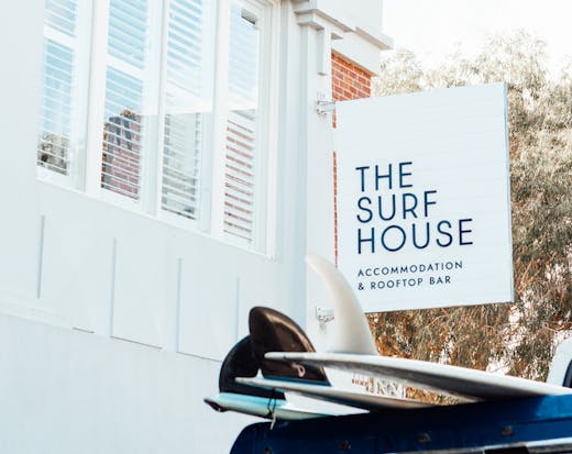 The white exterior of Byron Bay hostel, The Surf House.