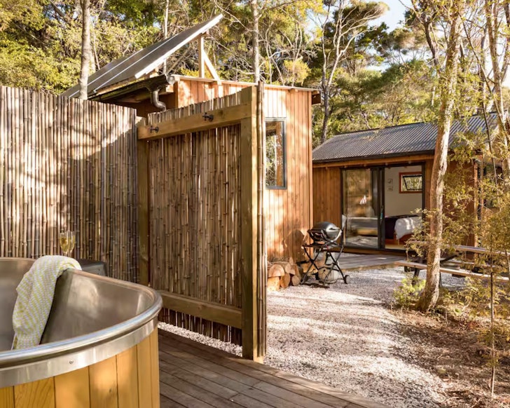 A view of the outdoor bath looking through to the bedroom at The Syrah Shack one of the best cabins in New Zealand