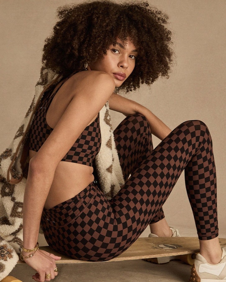 A woman wears a motorsport-inspired outfit from The Upside one of the best activewear brands