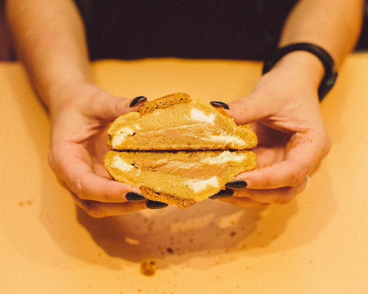 Rach holds a cross-section of a chunky cookie. 
