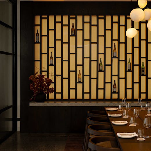 A backlit wall that doubles as a display case for meaningful empty wine bottles dubbed 