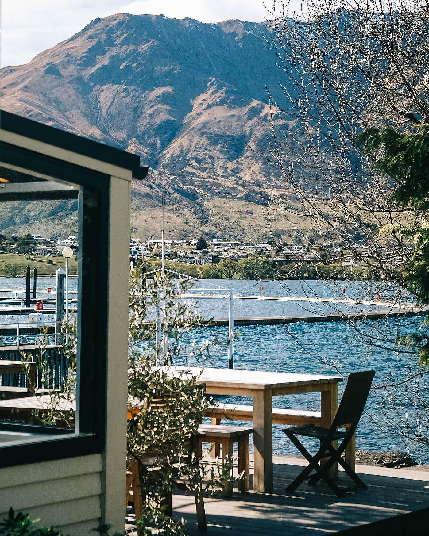 The outdoor dining space at The Boat Shed over overlooking the mountains