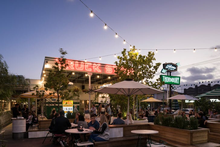 an outdoor restaurant with fairy lights