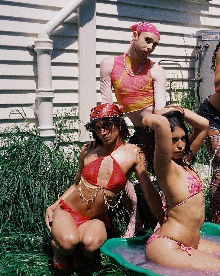 Three incredibly talented people from House Of Givenchy pose in a garden. 