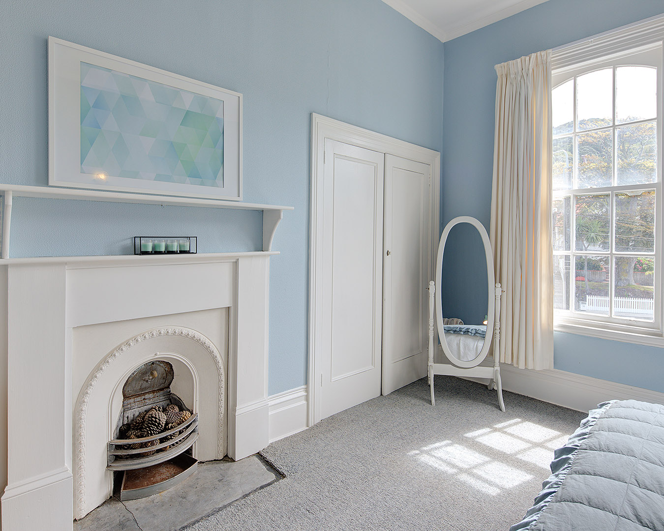 A lovely blue and white interior of a room with distinct Victorian-era vibes.