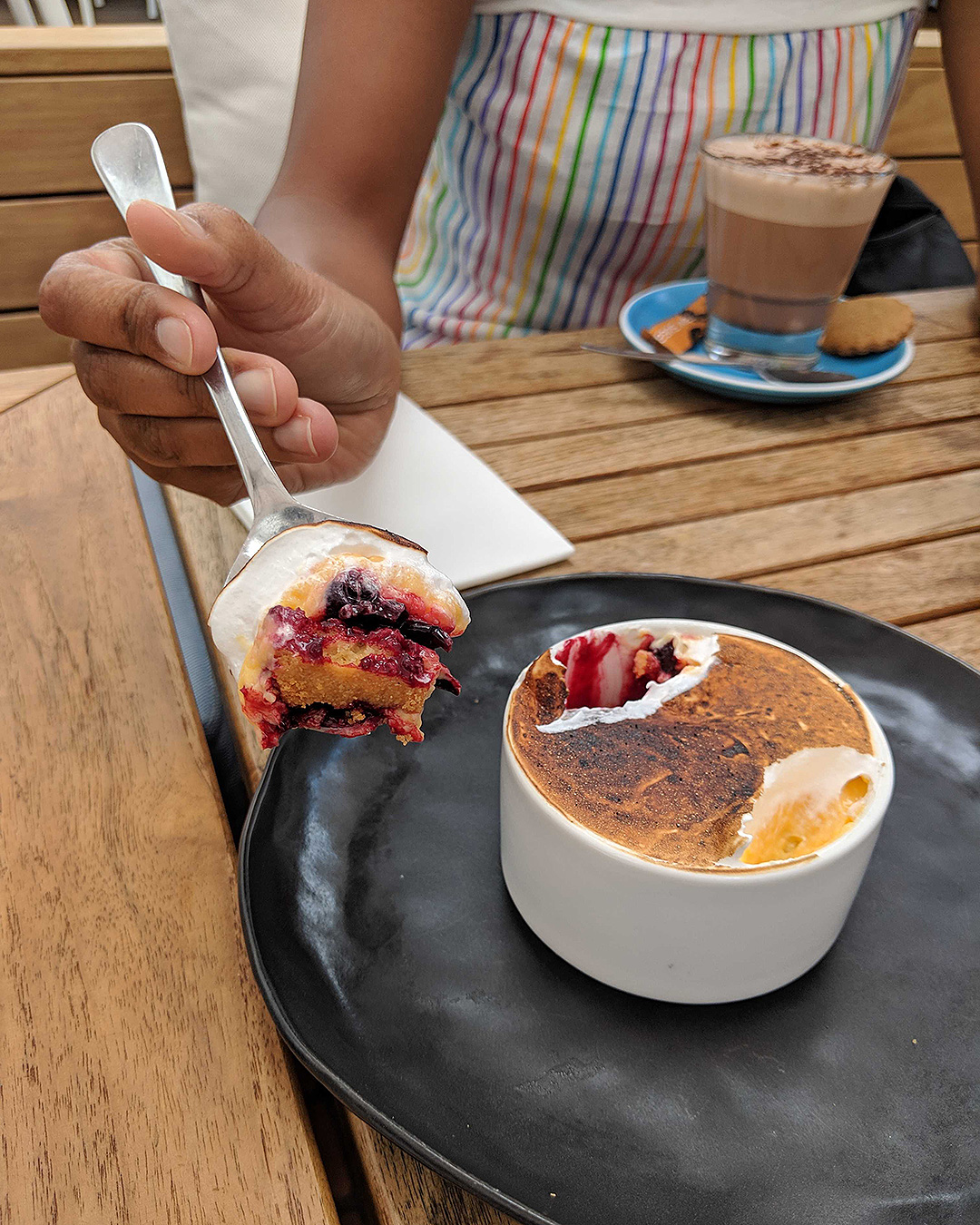 Someone digs into a dessert and a hot chocolate at Three Seven Two on Onetangi Beach.