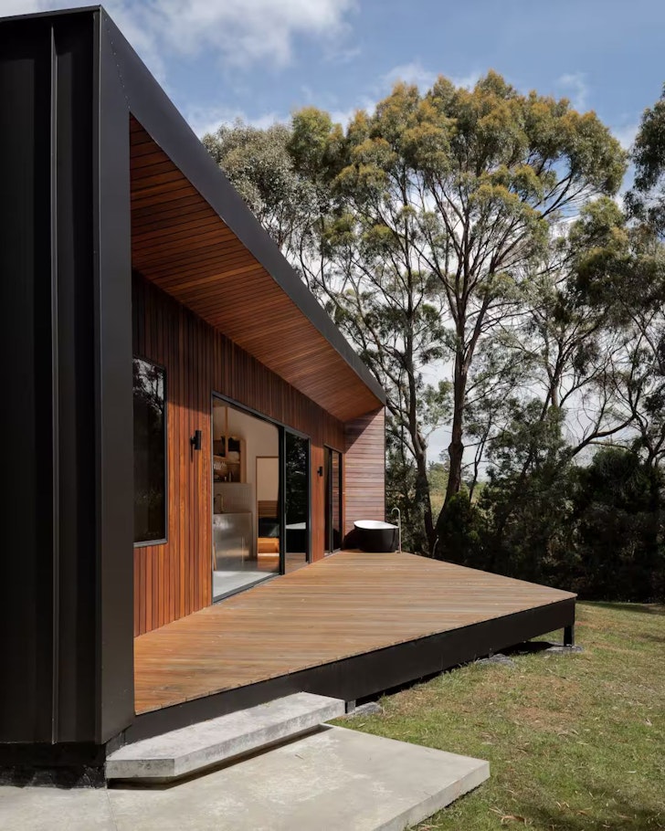An outside view of Three Capes Cabin and the outdoor bath in Tasmania