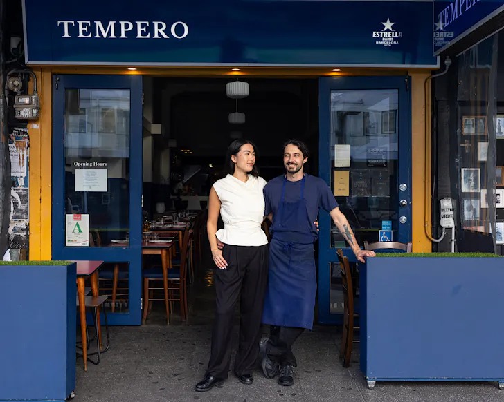 Tiffany and Fabio stand in the entranceway to Tempero, looking chic. 