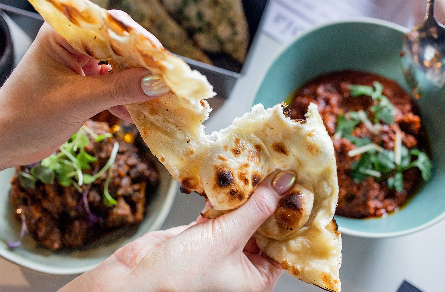 We dig into naan bread at Times Of India, one of the best restaurants open this King's birthday in Auckland.