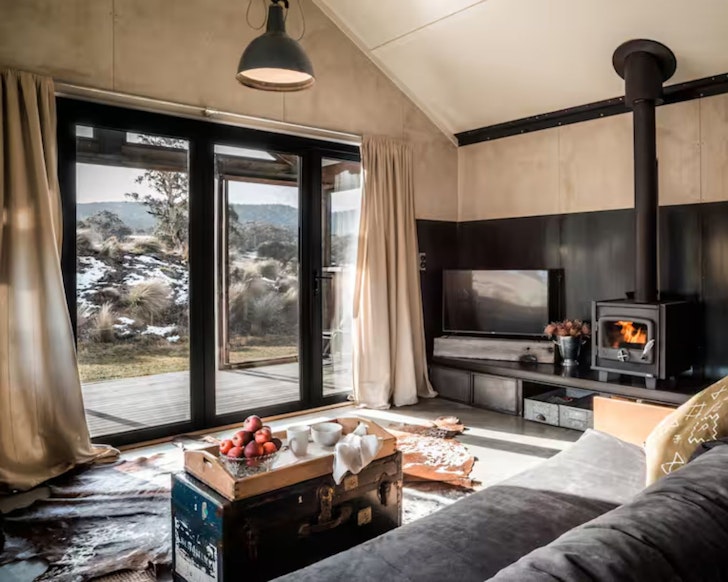 The living space with roaring fire at Tinkersfield one of the best NSW Airbnbs