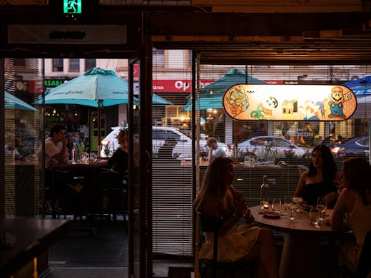 The inside of Tokyo Tina with people dining.