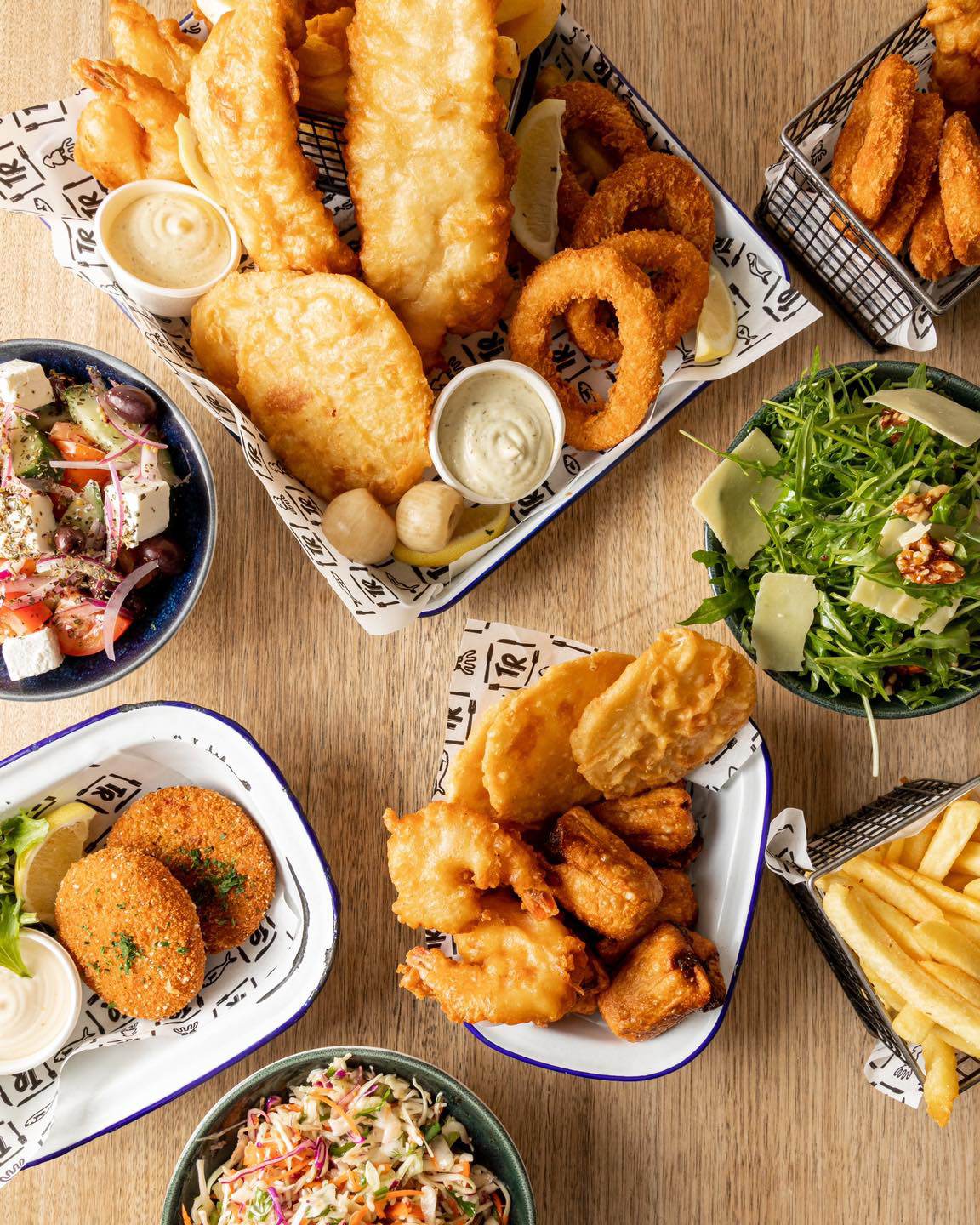A table with several dishes from a best fish and chips Melbourne shop.