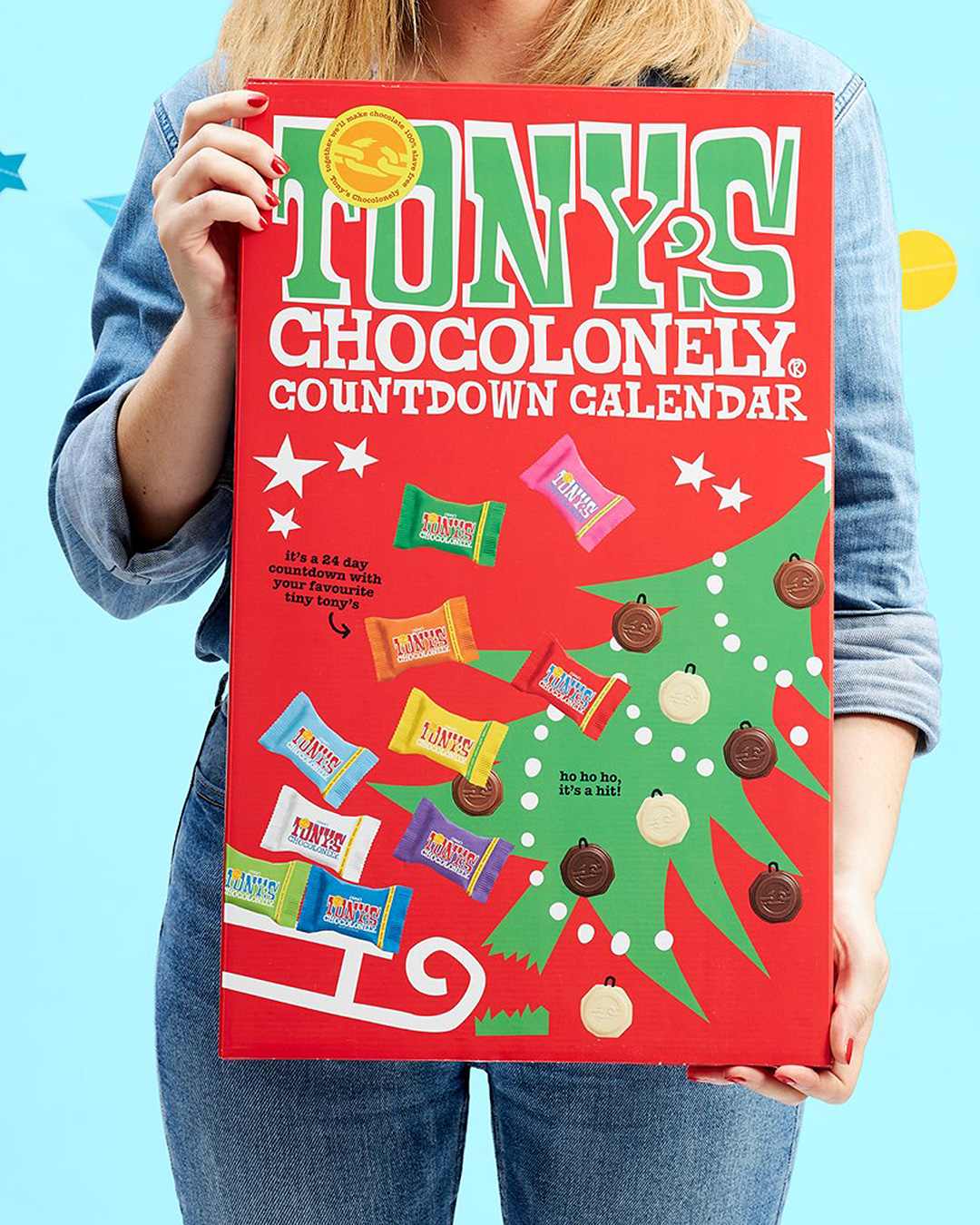 A woman holds a giant Tony's Chocolonely Advent Calendar.