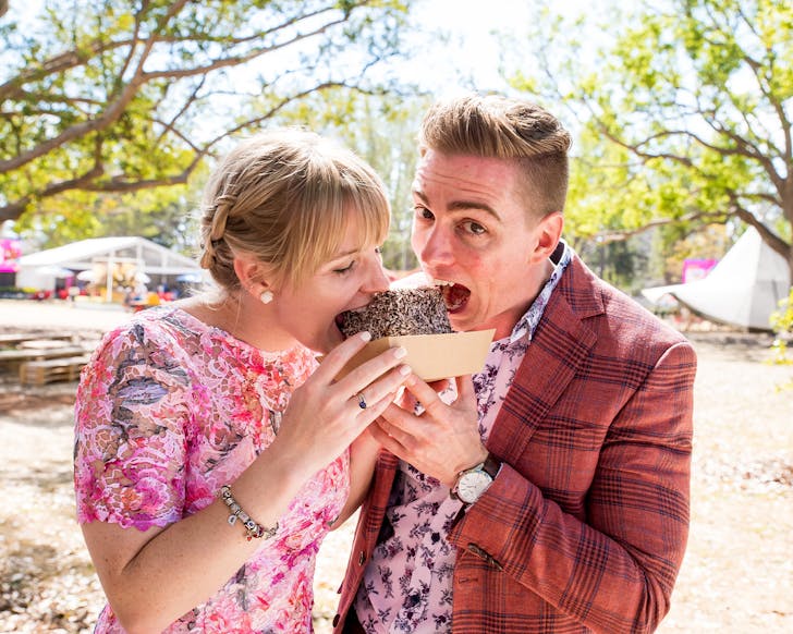 two people eating a lamington
