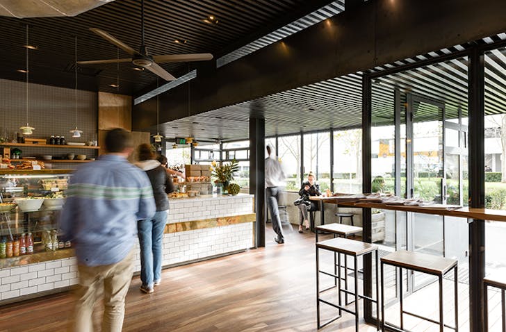 A white-tiled counter with people lining up to purchase a coffee at one of the best breakfast in Melbourne, Top Paddock in Richmond.
