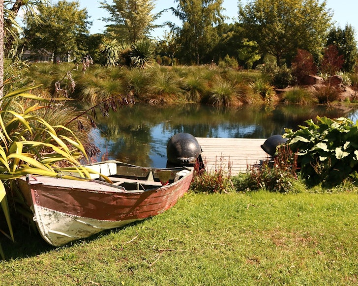 Boats by the creek at Totara Stream City Edge Farm Stay best Christchurch Airbnbs