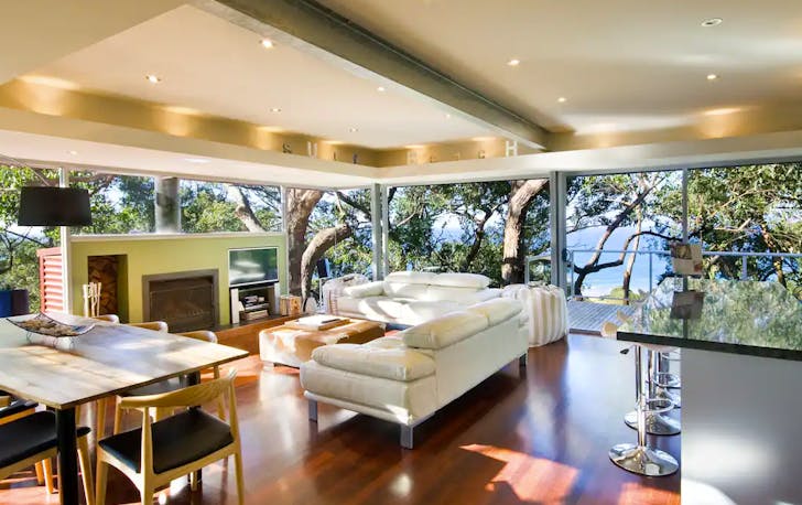 A sun-filled open-plan lounge room and kitchen, a potential choice of Lorne accommodation.