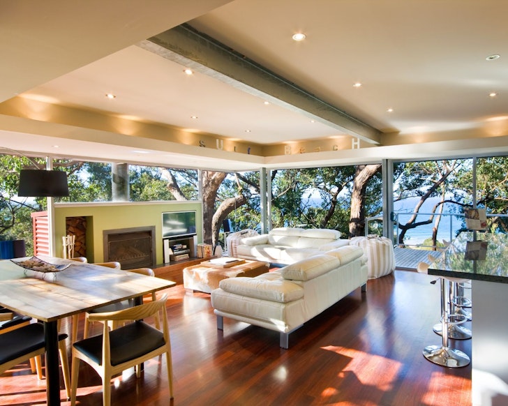 The living space with glass windows at Tranquility Base one of the best Airbnb accommodation options Lorne