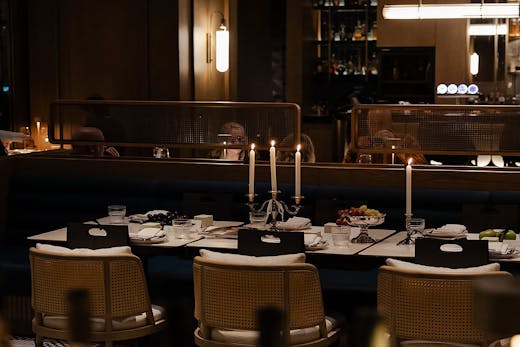 A sleek candlelit table sitting.
