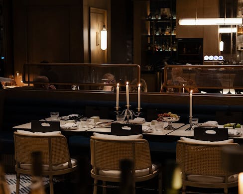 A sleek candlelit table sitting. 