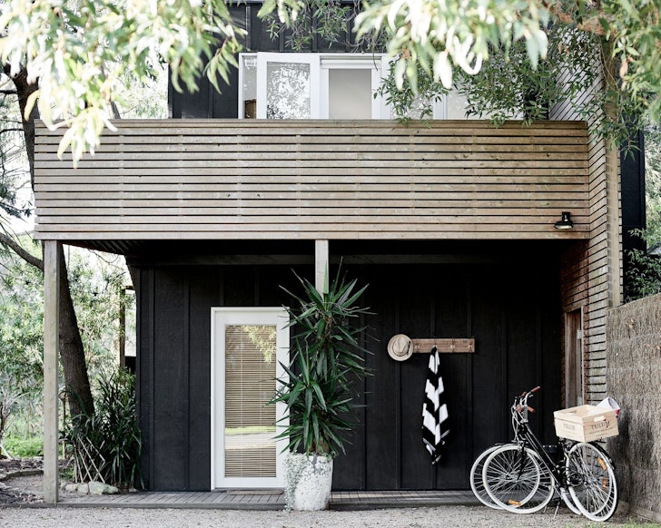 The black exterior with two bikes outside at Tulum one of the best beach house Airbnbs Victoria