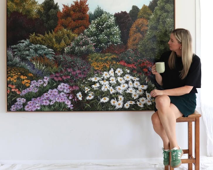 Artist Rachael Mayne with one of her beautiful floral artworks, featured at Turua Contemporary Gallery.  