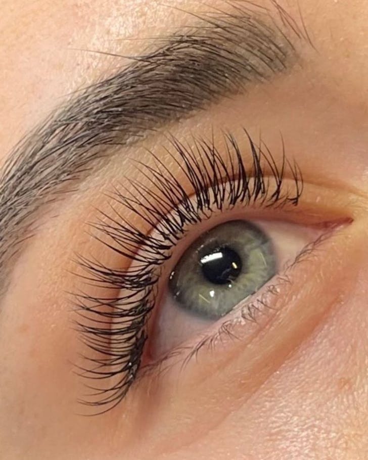 Close up of eyelash extensions from Lash Noir on green eye