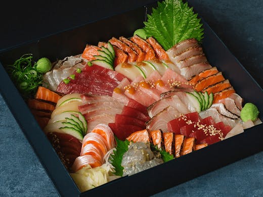a box of colourful sashimi sushi