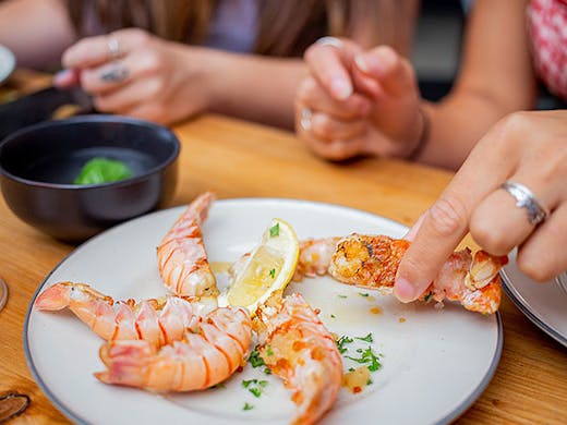 We get to grips with delicious prawns at Underground Bistro.