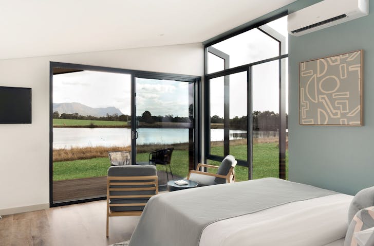 room with bed and table looking out to mountains